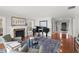 Spacious living area with a fireplace, a grand piano, and plenty of natural light, ideal for entertaining and relaxing at 9146 Bay Point Dr, Orlando, FL 32819