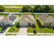 An aerial view of the home, showcasing its position in a sunny neighborhood with green lawns at 984 Chanler Dr, Haines City, FL 33844