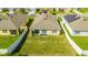 An aerial view of the home with a fenced backyard, showing the patio area and lawn at 984 Chanler Dr, Haines City, FL 33844