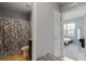 Bathroom showcasing a shower, granite sink, and access to the bedroom at 984 Chanler Dr, Haines City, FL 33844