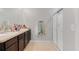Bathroom features a double vanity, a shower with glass doors, and neutral finishes at 984 Chanler Dr, Haines City, FL 33844