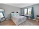 Bright bedroom features a white bed, a work area near the window, and a full-length mirror at 984 Chanler Dr, Haines City, FL 33844