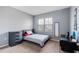 Cozy bedroom with a full-size bed, large window, and sleek black desk at 984 Chanler Dr, Haines City, FL 33844