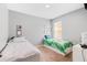 Shared bedroom with two twin beds, lots of natural light, and framed art on the walls at 984 Chanler Dr, Haines City, FL 33844