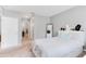 Comfortable bedroom with grey walls, a queen bed, and an adjacent hallway to additional rooms at 984 Chanler Dr, Haines City, FL 33844