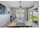 Bright dining room with a large wooden table, a window providing natural light, and access to the patio at 984 Chanler Dr, Haines City, FL 33844
