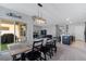 Open-concept dining area seamlessly connects to the living room, a view of the lanai, and a modern kitchen island at 984 Chanler Dr, Haines City, FL 33844