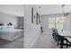 Open concept dining room featuring a modern light fixture and view into the connected bedroom at 984 Chanler Dr, Haines City, FL 33844