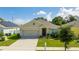 Charming single-Gathering home featuring a two-car garage, well-maintained lawn, and inviting front entrance at 984 Chanler Dr, Haines City, FL 33844
