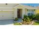 Close up of a single Gathering home with a two-car garage, lawn, and attractive landscaping at 984 Chanler Dr, Haines City, FL 33844