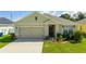 Charming single Gathering home with a two-car garage, lawn, and attractive landscaping at 984 Chanler Dr, Haines City, FL 33844