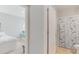 Hallway leading to a bedroom and bathroom, each with doors slightly ajar, allowing a glimpse into each room at 984 Chanler Dr, Haines City, FL 33844
