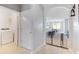 Hallway featuring tile floors and arched entrance to kitchen and living area with laundry closet at 984 Chanler Dr, Haines City, FL 33844