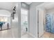 Hallway view reveals an open concept living/dining room, bedroom and bathroom with shower/tub combo at 984 Chanler Dr, Haines City, FL 33844