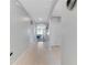 A hallway showcases neutral walls, tile flooring, and leads to an archway overlooking the dining area at 984 Chanler Dr, Haines City, FL 33844