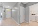 Inviting hallway with neutral tile flooring leads to the front door and laundry room at 984 Chanler Dr, Haines City, FL 33844