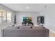Living area with a comfortable sofa, a large window providing natural light, and a modern entertainment center at 984 Chanler Dr, Haines City, FL 33844