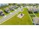 Aerial view of a Gathering-friendly neighborhood with a playground and well-maintained lawns at 984 Chanler Dr, Haines City, FL 33844