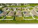Aerial view of several homes in a suburban neighborhood with manicured lawns and solar panels at 984 Chanler Dr, Haines City, FL 33844