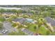 Aerial view highlighting the community pool, clubhouse, parking, and lush landscaping at 9900 Sweepstakes Ln # 1, Orlando, FL 32837