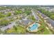 Overhead view of the community pool, clubhouse, and palm trees throughout complex at 9900 Sweepstakes Ln # 1, Orlando, FL 32837