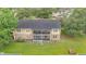 Back of the building with covered patio and balcony overlooking a community playground at 9900 Sweepstakes Ln # 1, Orlando, FL 32837