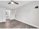 Open bedroom leads to en-suite bathroom, featuring modern wood-look floors at 9900 Sweepstakes Ln # 1, Orlando, FL 32837