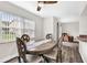 Bright dining room with wood-style floors, an oval table, and a view of the outdoors through large windows at 9900 Sweepstakes Ln # 1, Orlando, FL 32837