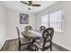 Warm dining area offers a round wood table, decorative chairs, and a ceiling fan for added comfort at 9900 Sweepstakes Ln # 1, Orlando, FL 32837