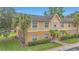 Charming exterior with palm trees, green lawn, and side air conditioning units at 9900 Sweepstakes Ln # 1, Orlando, FL 32837