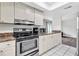Well-lit kitchen with stainless steel appliances, ample storage, and a functional layout, perfect for cooking at 9900 Sweepstakes Ln # 1, Orlando, FL 32837