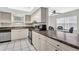 Bright kitchen with ample cabinets, countertops, tile floors, and a dining area with natural light at 9900 Sweepstakes Ln # 1, Orlando, FL 32837