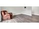 Spacious living room features modern floors, and a comfortable brown armchair, set against neutral walls at 9900 Sweepstakes Ln # 1, Orlando, FL 32837