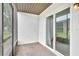 View of the screened-in patio with sliding glass doors and neutral wall colors providing an outdoor living space at 9900 Sweepstakes Ln # 1, Orlando, FL 32837