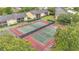 Aerial view of community tennis courts surrounded by trees and greenery at 9900 Sweepstakes Ln # 1, Orlando, FL 32837