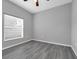 Bedroom featuring wood look flooring and large window at 3956 Shadowind Way, Gotha, FL 34734