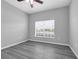 Bright bedroom with gray vinyl floors and a large window allowing for lots of natural light at 3956 Shadowind Way, Gotha, FL 34734