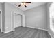 Neutral bedroom featuring a ceiling fan, vinyl floors and a closet with white bi-fold doors at 3956 Shadowind Way, Gotha, FL 34734