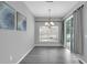 Dining area with sliding glass doors, chandelier, and view of the backyard pool at 3956 Shadowind Way, Gotha, FL 34734