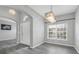 Bright entryway with high ceilings, a modern light fixture, gray flooring, and lots of natural light at 3956 Shadowind Way, Gotha, FL 34734