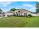 Well-maintained home exterior featuring a lush green lawn and neatly trimmed landscaping at 3956 Shadowind Way, Gotha, FL 34734