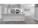 Modern kitchen features granite countertops, stainless steel appliances, and views into the living area at 3956 Shadowind Way, Gotha, FL 34734
