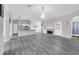 Open living space featuring modern gray flooring, chandelier, fireplace, and views into the kitchen at 3956 Shadowind Way, Gotha, FL 34734