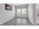 Cozy room with gray flooring, natural light from two windows, and white trim throughout at 3956 Shadowind Way, Gotha, FL 34734