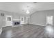 Large living room featuring a fireplace, gray flooring, and a view of the backyard through a glass door at 3956 Shadowind Way, Gotha, FL 34734