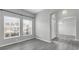 Open living room featuring stylish gray flooring, a large window, and an arched entryway at 3956 Shadowind Way, Gotha, FL 34734