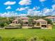 Aerial view showcases estate home, lush landscaping, and sprawling backyard with nearby waterfront at 11103 Bridge House Rd, Windermere, FL 34786