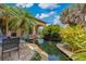 Stunning backyard oasis featuring a koi pond with lush landscaping and a cozy outdoor seating area at 11103 Bridge House Rd, Windermere, FL 34786