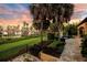 Spacious backyard with tropical landscaping and scenic lake views at sunset at 11103 Bridge House Rd, Windermere, FL 34786