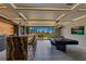 Entertainer's delight showcasing a stylish bar area, pool table, and seamless outdoor access for ultimate relaxation at 11103 Bridge House Rd, Windermere, FL 34786